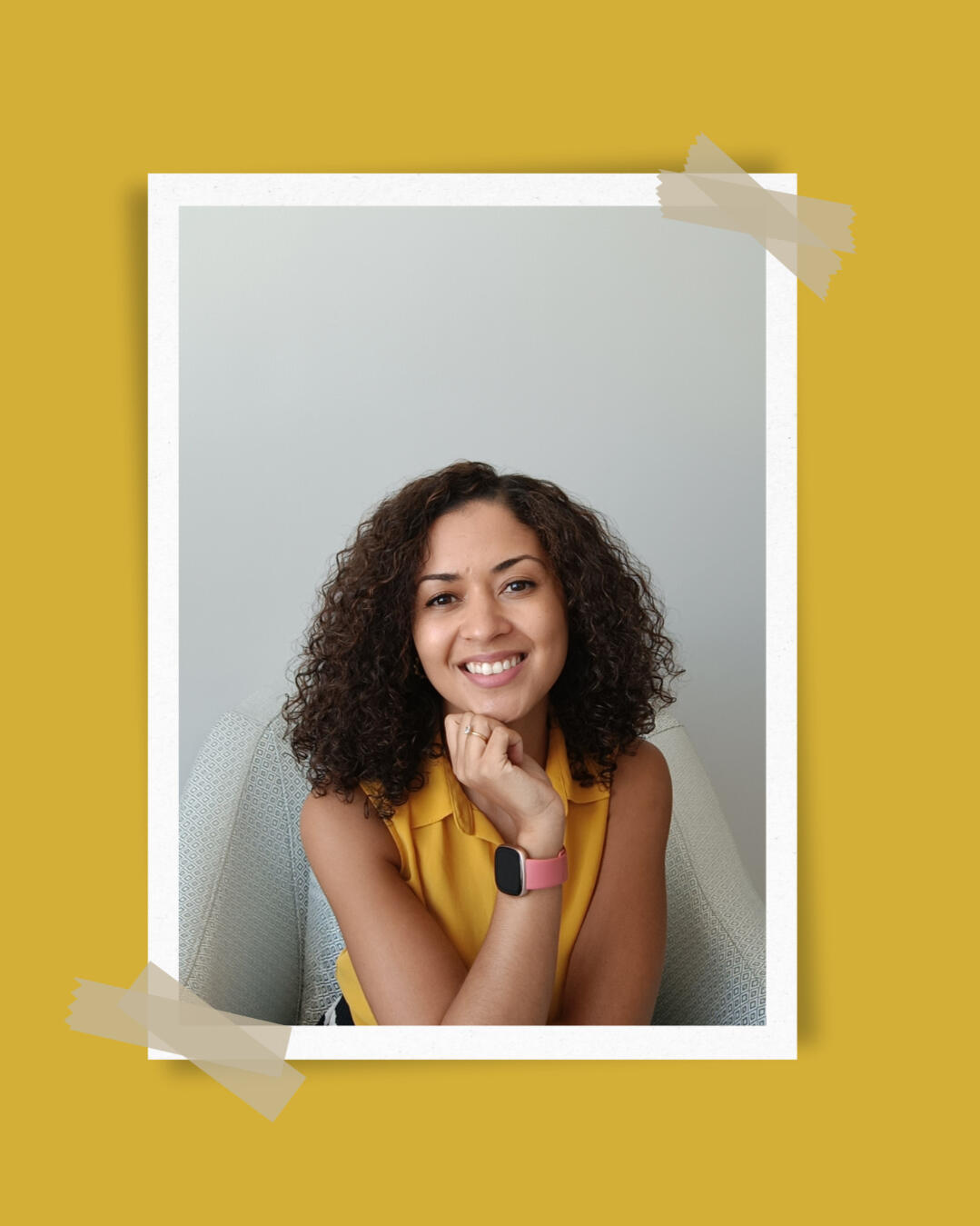 Jess Cruse, Global Voice & Storytelling Strategist, smiling with arms crossed in a modern coaching space with a plant and chair, representing leadership and voice empowerment.